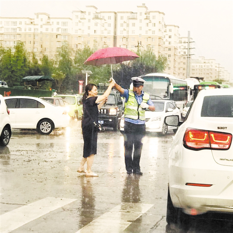 市民为雨中执勤交警送伞